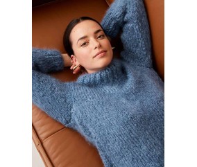 Pull Yolita bleu faïence en mohair à col roulé, porté par une femme allongée - Patron tricot Phildar
